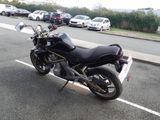 a black motorcycle parked on the side of the road
