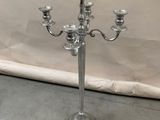 a silver candelab with three candles on it