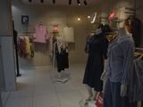 mannequins in a clothing store with clothes on display