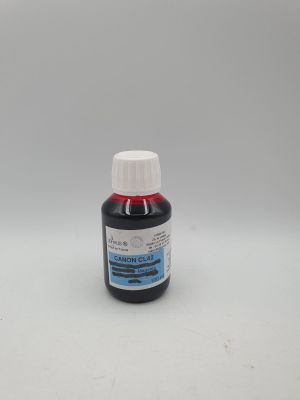 a close up of a bottle of liquid on a white surface