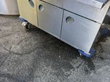 an image of a stainless steel kitchen with two sinks and a trash can