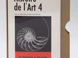 an open book sitting on top of a cardboard box next to a pair of scissors