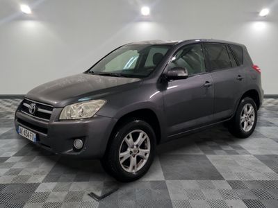 the grey toyota rav is parked in a room with a checkered floor