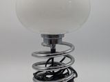 a white light that is sitting on top of a spring