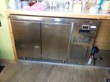 a stainless steel refrigerator in the corner of a kitchen