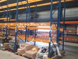 warehouse racking with pallets and boxes of goods in a warehouse