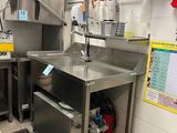 a kitchen with stainless steel appliances and a sink