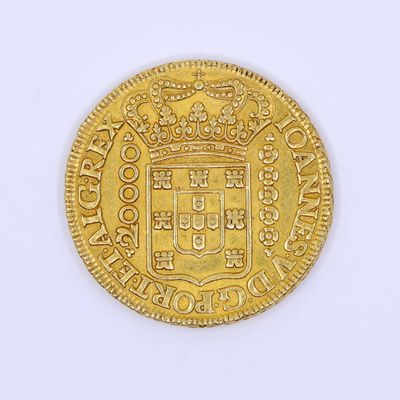 a close up of a gold coin on a white surface