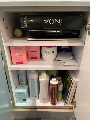 an image of a bathroom cabinet with a lot of items in it