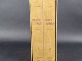 pair of books in cardboard box on grey background with black background
