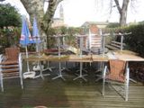 une table et des chaises sur une terrasse en bois dans le jardin