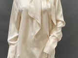 a mannequin mannequin wearing a white blouse and white pants