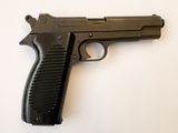 un pistolet posé sur une surface blanche
