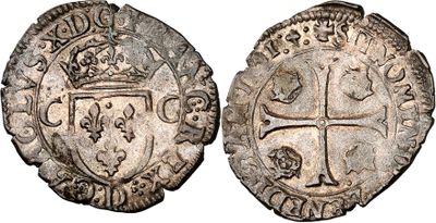 a silver coin with a cross on the front and a shield on the back