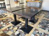 two tables that are sitting on a tiled floor