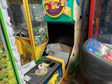 many arcade machines in a room with a lot of boxes