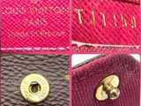 a close up of a pink purse with a gold button
