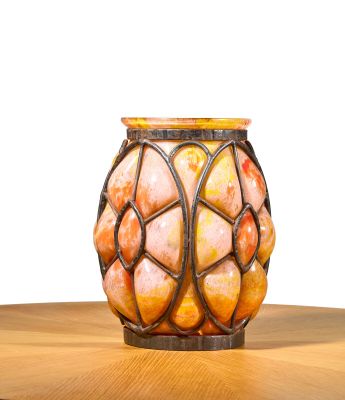 a glass vase with a pattern on it sitting on a table