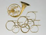 an image of a brass french horn and other musical instruments on a white surface