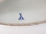 a close up of a white bowl with blue writing on it