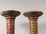 pair of antique wooden candlesticks on a white background