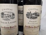 several bottles of wine are lined up on a table