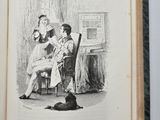 an open book with a drawing of a woman sitting in a chair next to a cat