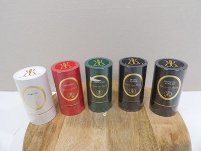 several different types of candles are lined up on a cutting board