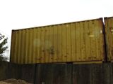 a large yellow container sitting on top of a pile of dirt