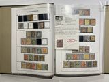 an open book with stamps on it sitting on a table