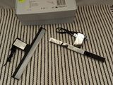 an image of a pair of scissors and a pen on a bed