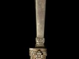 a silver spoon sitting on top of a wooden table