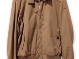 an image of a jacket hanging on a hanger on a wall