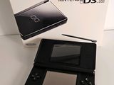 a nintendo ds lite in the box next to the box
