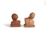two wooden sculptures of a man and a woman on a white background