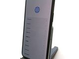a phone that is sitting on a stand on a table