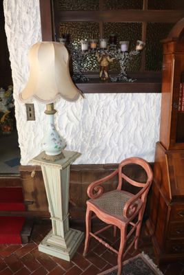 a lamp and a chair in the corner of a room