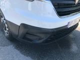 the front end of a white van parked in a parking lot