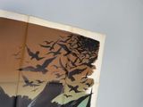 an open book with a picture of birds flying in the sky