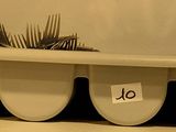 three surfboards sitting on top of each other on a shelf