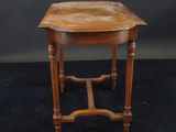 a small table with a wooden top on a black background