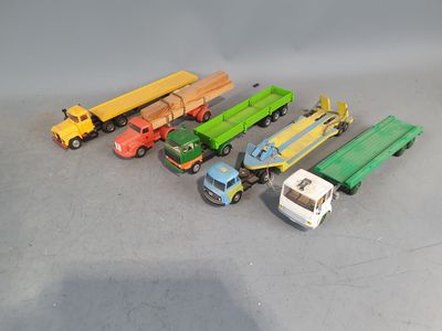 several toy trucks are lined up in a row on a gray surface