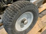 a small tractor with a big tire on a pallet