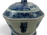a blue and white bowl with a lid on a white surface