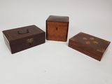 trois petites boîtes en bois posées sur une surface blanche