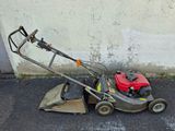 a small lawn mower that is sitting on the ground
