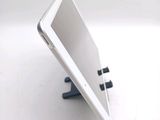 a tablet computer sitting on a stand on a white surface