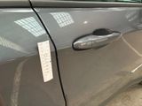 a close up of a car door handle with a sticker on it