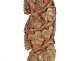 an image of a wooden statue of a woman with grapes on her head