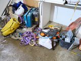 a pile of luggage sitting on the floor of a garage